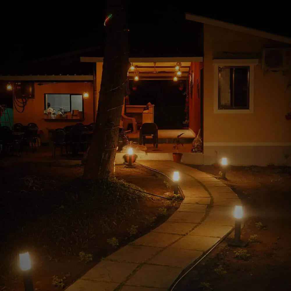 Sachu's resort view at night having small streetlight lamb in lawn